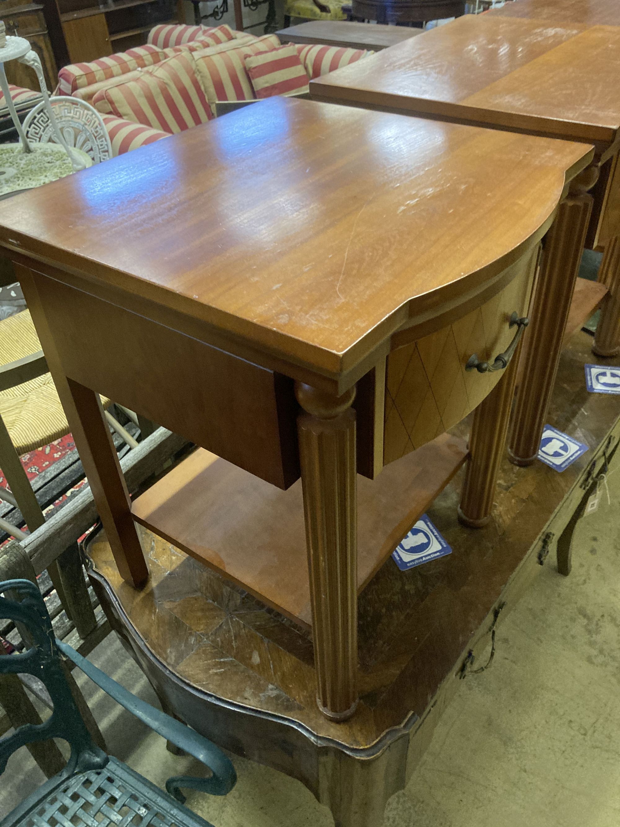 A pair of walnut bowfront two tier bedside tables, width 50cm, depth 50cm, height 61cm